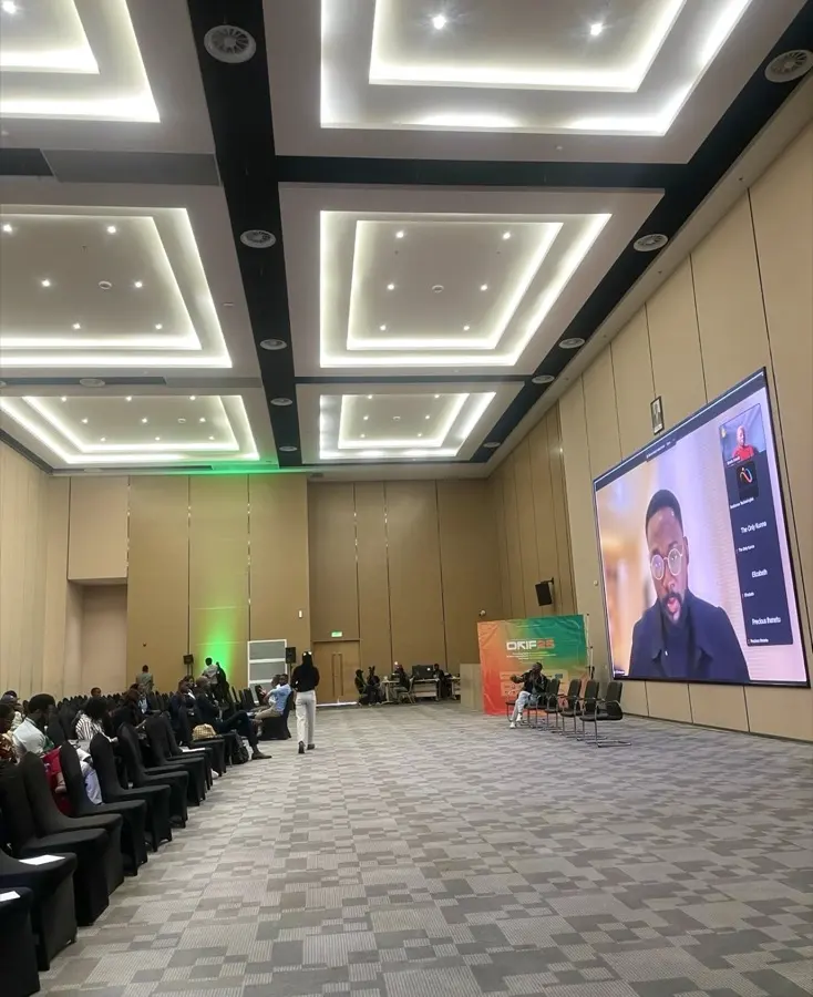 The DRIF25 hall filling ahead of the Resilience Technologies session, the stage screen lit at the far end.