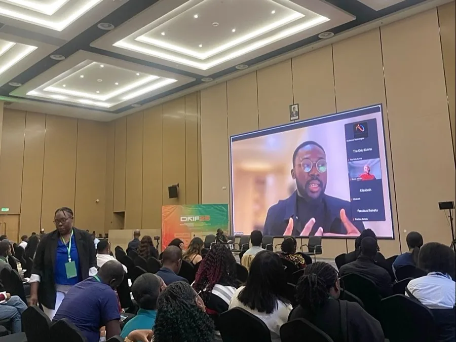 A full hall at DRIF25 watching the Resilience Technologies session, the speaker on the main screen beside the forum banner.
