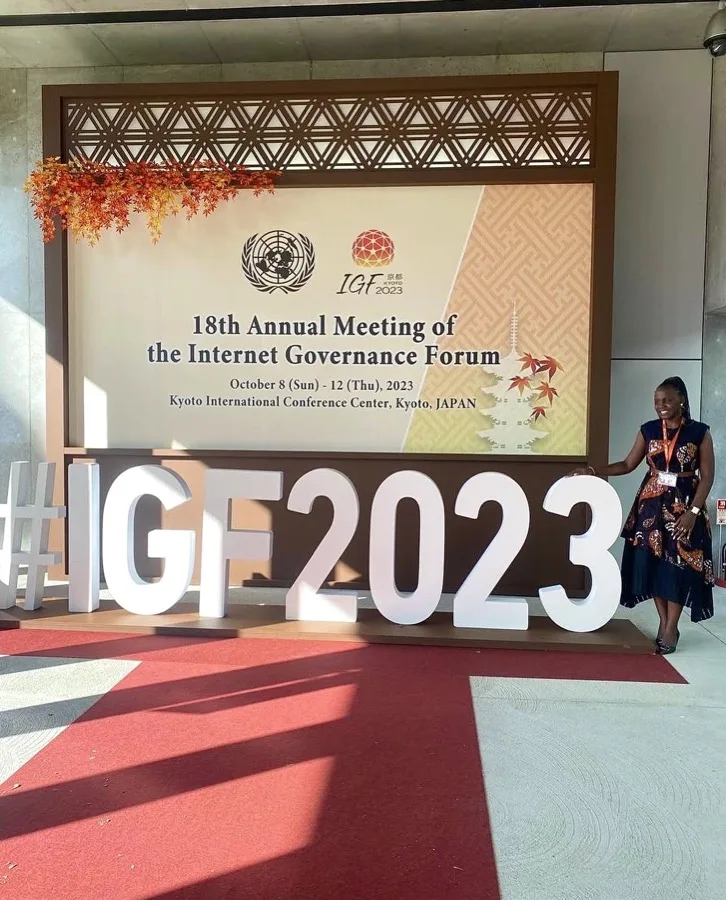 The Resilience Technologies delegate at the 18th Internet Governance Forum in Kyoto, beside the forum signage.