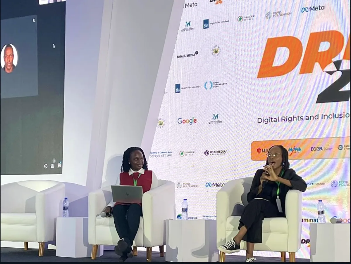 Two Resilience Technologies panellists seated on the DRIF24 stage, a remote participant on the screen beside them.