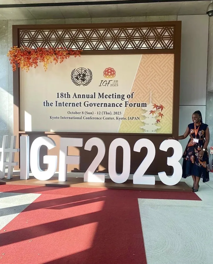 The Resilience Technologies delegate at the 18th Internet Governance Forum in Kyoto, beside the forum signage.